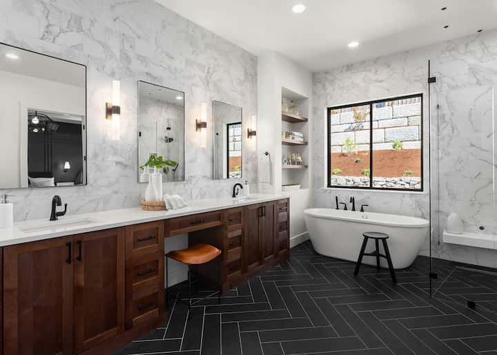 A complete bathroom remodel with vanities, walk-in shower, stand alone tub, and stylish floor tiles turns a bathroom into a modern Woodland, CA oasis.